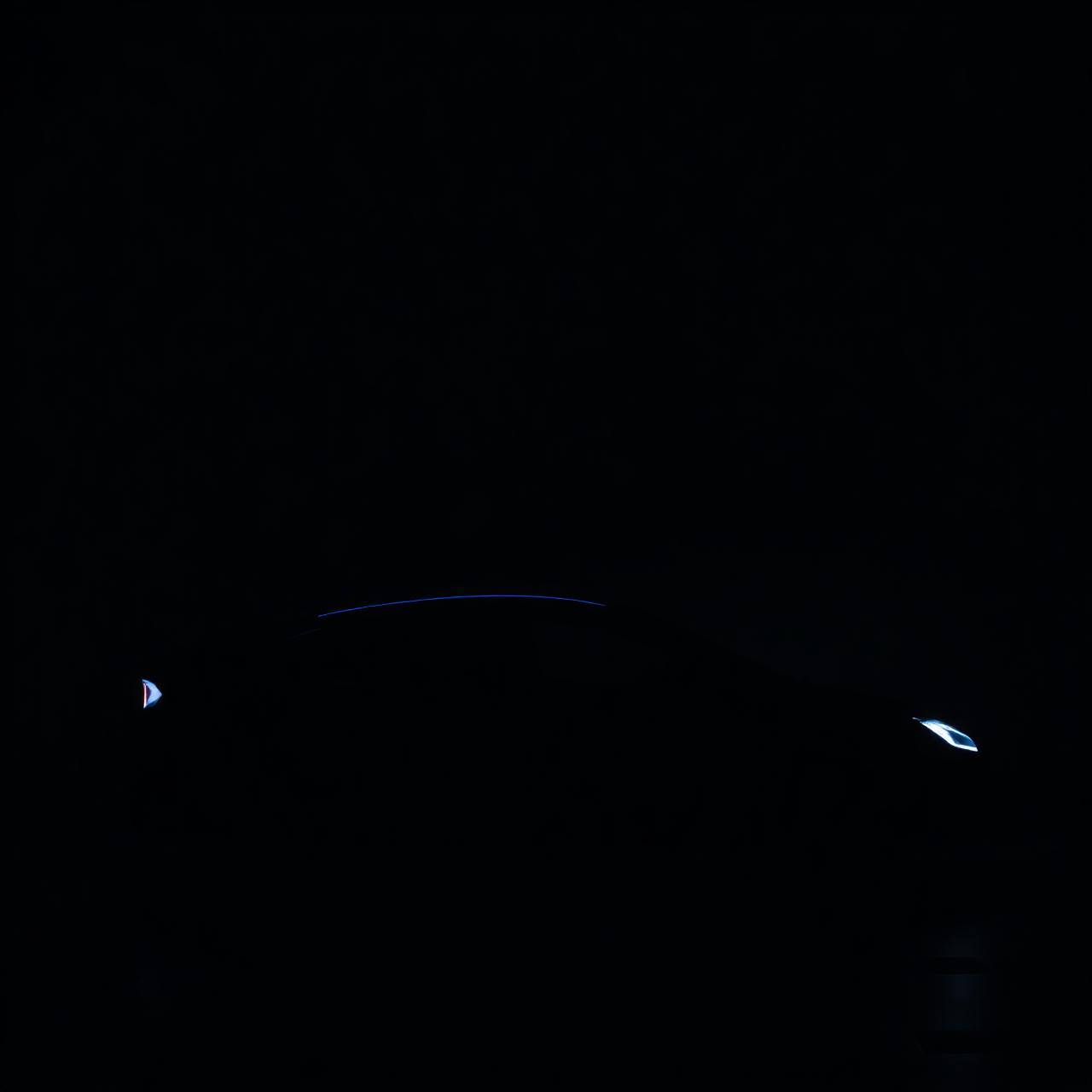 A sculpted electric vehicle silhouette under studio lighting.